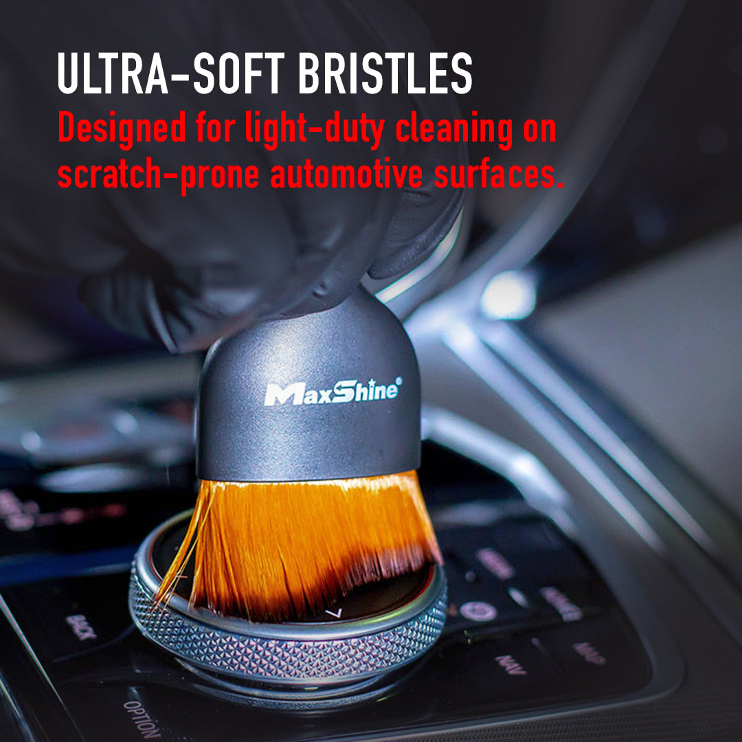 Official MaxShine 704621 handheld ultra-soft detailing brush shown cleaning a delicate interior surface.